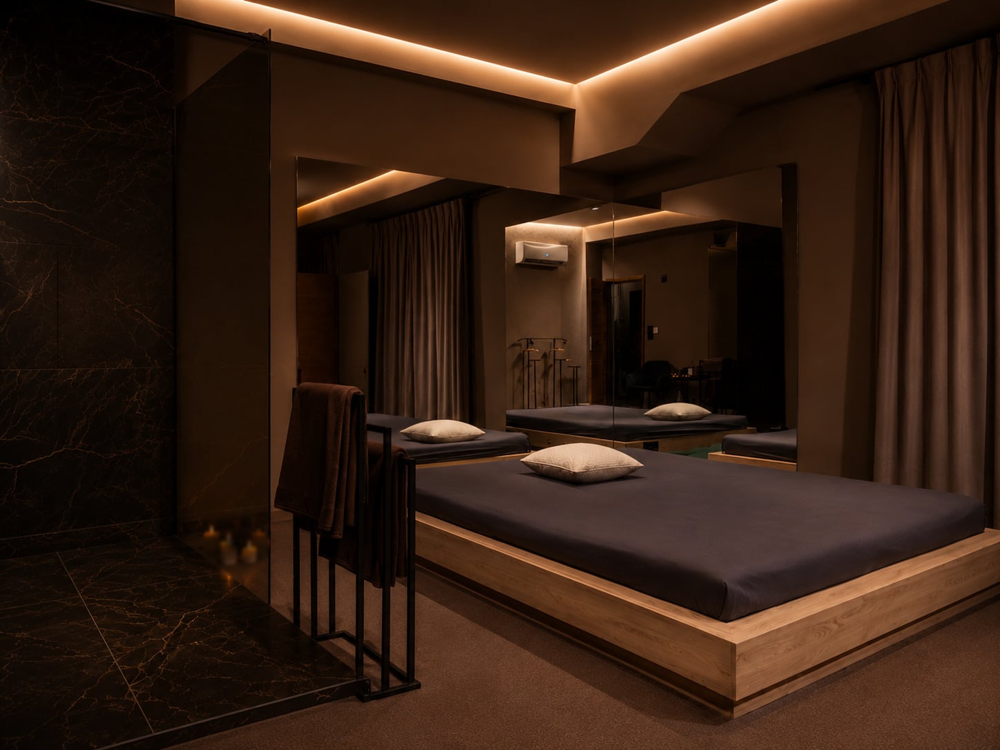 Massage room: a wide mat, a mirrored wall and warm light along the ceiling